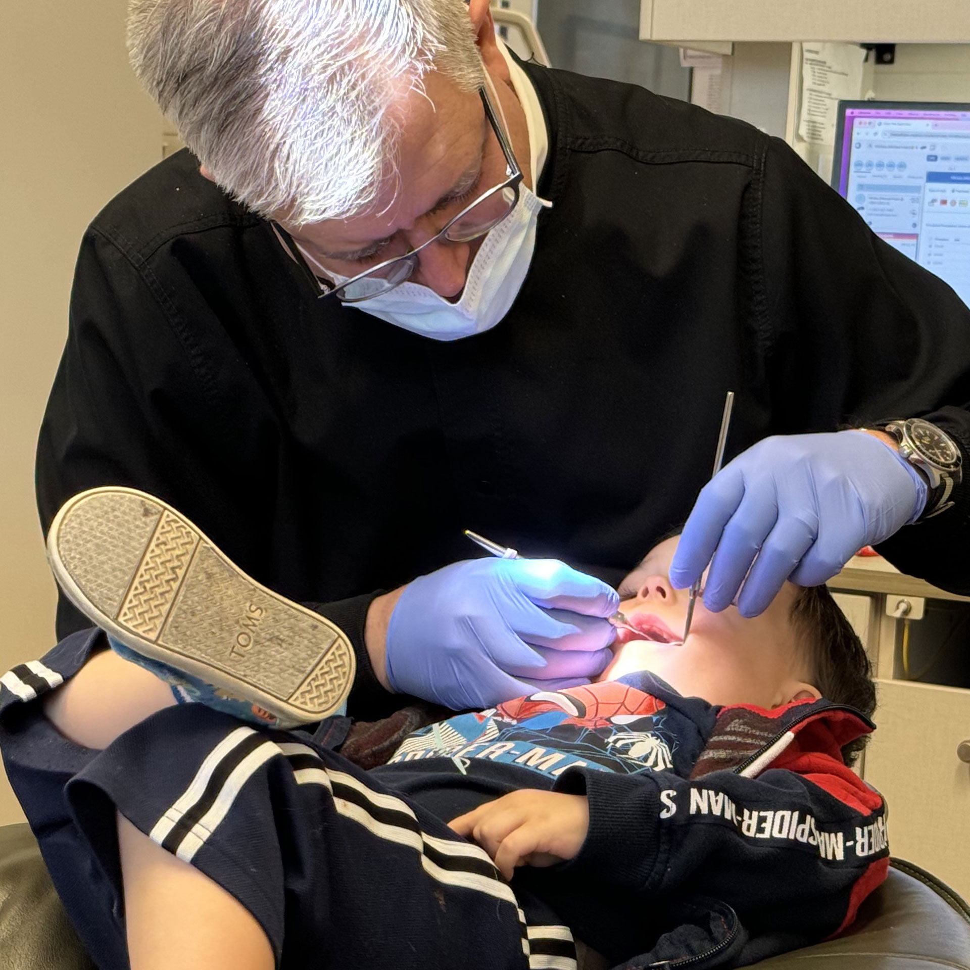 Dr. Matz performing dental exam on young patient