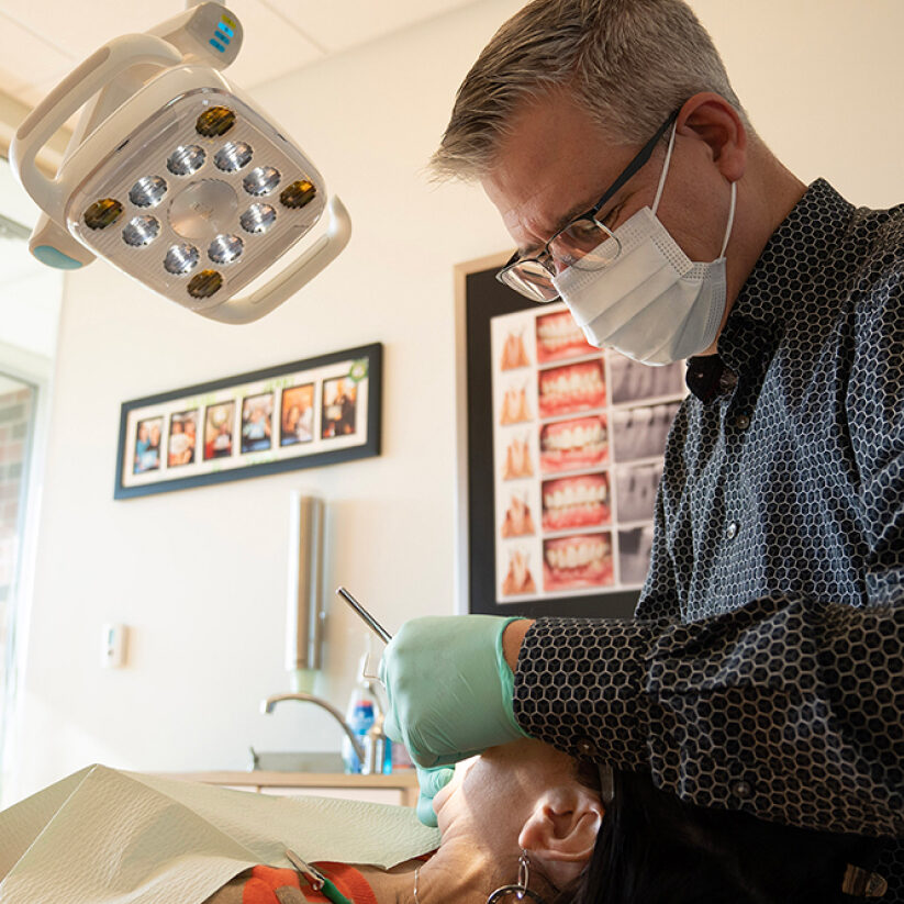 Dr. Matz performing dental exam on patient