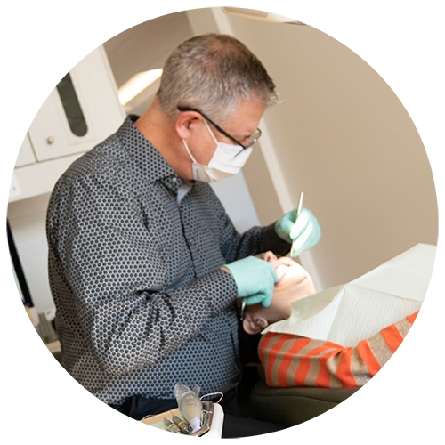 Dr. Matz performing dental exam on patient