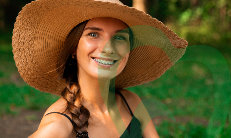 Lady in big hat smiling with braces